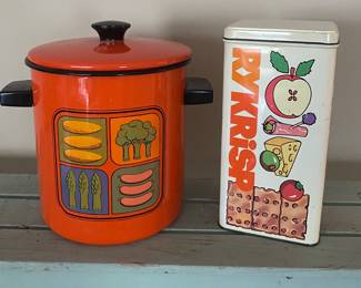 a vintage 1970s enamelware stockpot featuring a colorful vegetable graphic that includes corn, broccoli, asparagus, and sausage & vintage cracker tin