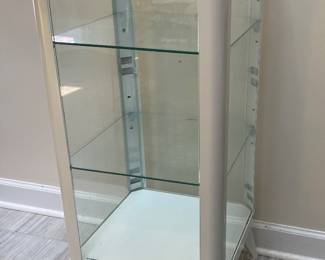 vintage-style white metal medical cabinet features glass panels and shelves