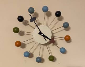 Vintage-style Vitra Ball Clock by George Nelson features distinct multicolored wooden balls on metal spokes