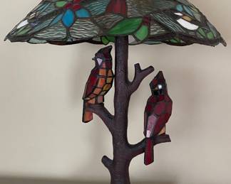 River of Goods 23.75-inch tall stained glass cardinal table lamp featuring a tree-trunk base and three lights