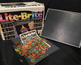 vintage Hasbro Lite-Brite set features the original 1967 logo on the packaging and includes the black plastic screen, instructions, and a large assortment of colorful pegs
