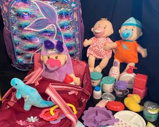 Manhattan Toy Wee Baby Stella dolls feature soft bodies and include various small accessories for imaginative role-play & rolling mermaid backpack/luggage