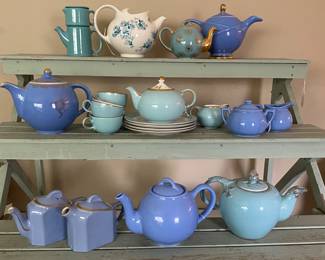 collection features several vintage Hall China teapots, including the "Hook Cover" and "Windshield" models from the 1940s in pastel blue and cobalt shades