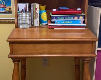 vintage Early American style secretary desk and hutch features a lift-top slanted writing surface.