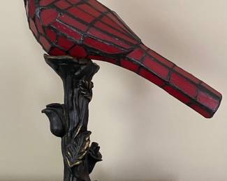 River of Goods stained glass cardinal accent lamp, featuring a red bird perched on a bronzed polyresin tree trunk base