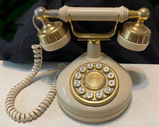 vintage Western Electric "Celebrity" phone features a cream-colored body with gold trim and a circular push-button layout