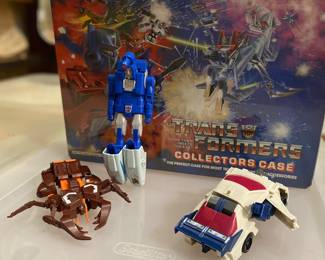 Vehicles & case including a vintage 1986 Transformers Generation 1 (G1) Scourge figure, which originally released in Japan by Takara and internationally by Hasbro