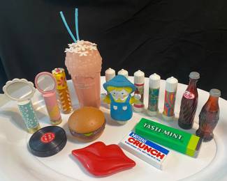 collection features various vintage 1970s Avon novelty lip gloss containers shaped like foods