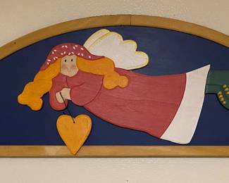 folk art wooden plaque features a hand-painted angel holding a heart, designed for wall or door decoration
