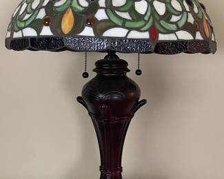 Meyda Tiffany Creole Table Lamp featuring a stained glass shade with a geometric vine pattern and a mahogany bronze base