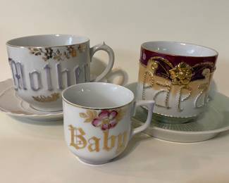 vintage German porcelain mugs, branded by ZPF, feature embossed text such as "Mother," "Papa," and "Baby" highlighted with gold trim