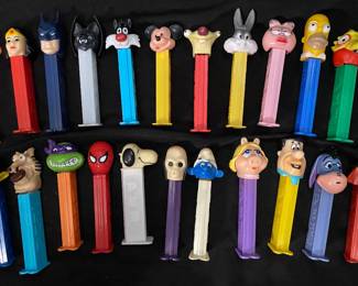collection features a variety of cartoon and character-themed PEZ candy dispensers, including figures Batman, Garfield, Mickey Mouse, and Bugs Bunny