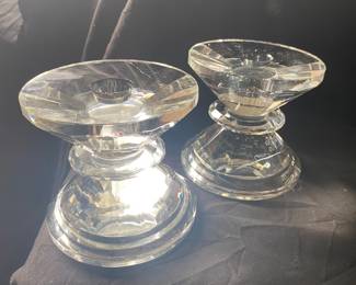 pair of heavy, faceted clear crystal candle holders feature a reversible design for both pillar and taper candles