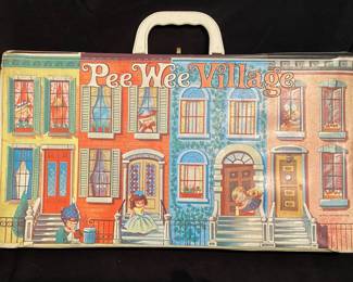 a vintage 1966 Uneeda Ideal Pee Wee Village carrying case, featuring a colorful city street graphic on the front