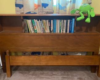 mid-century modern style wood bed frame features a built-in bookcase headboard with open shelving