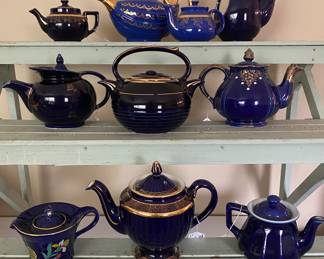 collection features various vintage cobalt blue teapots by the Hall China Company, typically decorated with 22k gold trim