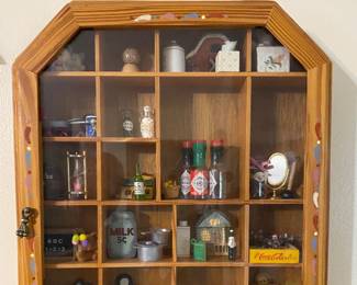 vintage wood curio cabinet with a glass door, often used to display trinkets and miniatures
