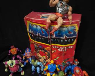 vintage 1980s Mattel Masters of the Universe collector's case, accompanied by various loose action figures