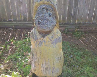 Lot 79: Weathered yellow wooden statue yard art