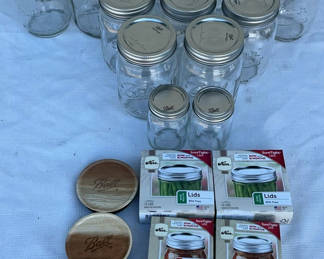 Lot 87: Mason jars with metal lids, Kerr lid boxes, and Ball wooden coasters