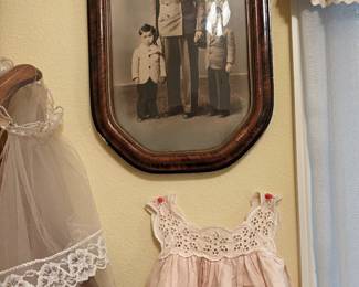 Antique photo in original frame & vintage children’s clothing