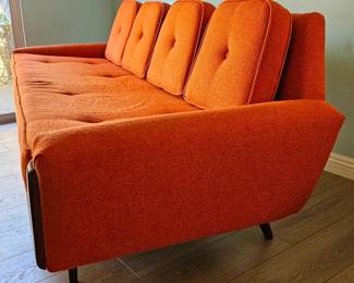MCM Adrian Pearsall-style Gondola Sofa in Vibrant Textured Orange Fabric with Walnut Wood Accents.