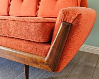 MCM Adrian Pearsall-style Gondola Sofa in Vibrant Textured Orange Fabric with Walnut Wood Accents.