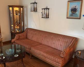 One of a pair of Hollywood Regency sofas