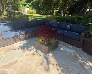 7 pc wicker sectional with navy cushions and wicker/glass coffee table