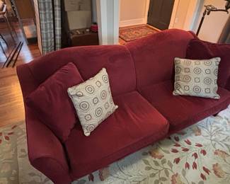 Red Velvet Camelback Sofa with Decorative Pillows