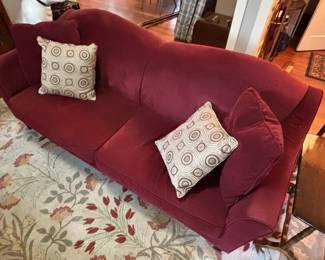 Red Velvet Camelback Sofa with Decorative Pillows