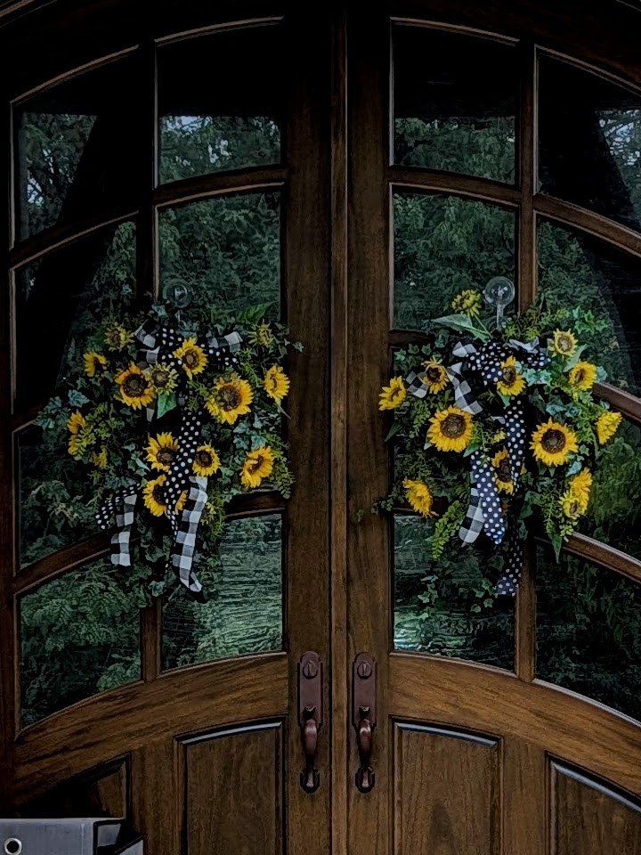 PAIR OF ARTIFICIAL SUNFLOWER WREATHS WITH BLACK & WHITE RIBBONS