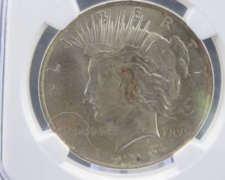 Lot 85. 1922 P Peace Silver Dollar slabbed and graded NGC MS 63