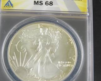 Lot 301. 1986 S Silver Eagle $1 coin with one troy ounce of .999 silver slabbed and graded ANACS MS 68