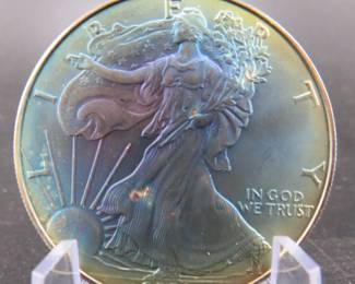 Lot 283. 2000 American Silver Eagle with major toning. One troy ounce of .999 Silver