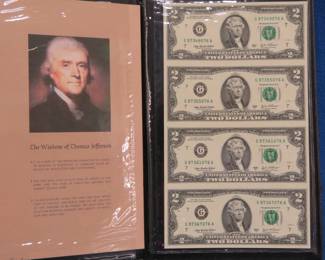 Lot 117. Four uncut 2003 Series A $2 bills in a folder from the World Reserve Monetary Exchange