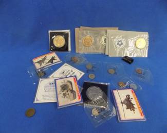 Lot 98. Coin Stew: Two Dollar medallion from the Sesquicentennial of the Oregon Trail. Golden Eagle Medallion. 1945 Netherlands Liberation stamp. Estonian coins. 1941 silver Mercury Dime. Two Buffalo and two V nickels. 1974 and 1976 Bicentennial medallions and First Day Covers. Three packs of Desert Storm trading cards. And more