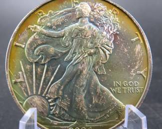 Lot 281. 2004 American Silver Eagle with major toning. One troy ounce of .999 Silver