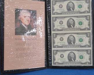 Lot 115. Four uncut 2003 Series A $2 bills in a folder from the World Reserve Monetary Exchange