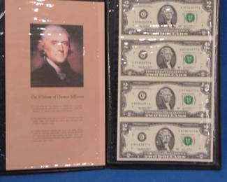Lot 116. Four uncut 2003 Series A $2 bills in a folder from the World Reserve Monetary Exchange
