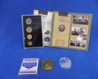 Lot 65. Collectible coins, unrecognized coins, and medallions. One set of four Russian coins. 50th Anniversary of the D-Day landings commemorative 50 pence coin. $10 Hutt River Province 50th Anniversary WWII coin. One Dollar 'We Will Never Forget" coin.