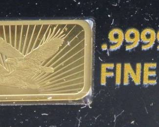 Lot 143. National Collector's Mint Double Eagle bar with 1/100th ounce (approx. 1/2" x 1/4") of pure .9999 gold. of pure .9999 gold. Identical to lot 140. The same photos were used.