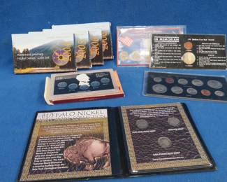 Lot 119. Nine collectible coin sets: Four Westward Journey sets with 6 Nickels each from 2004, 2005, and two from 2006. 1983 Mint sets from Denver and Philadelphia. Kennedy and Lincoln In Memorium Half Dollar and Penny. Three State Quarters. 1943 Wartime 5-Penny set. Three Buffalo Nickels