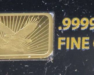 Lot 141. National Collector's Mint Double Eagle bar with 1/100th ounce (approx. 1/2" x 1/4") of pure .9999 gold. of pure .9999 gold. Identical to lot 140. The same photos were used.