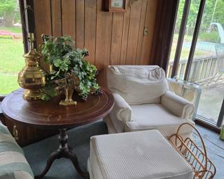 Wood Claw Foot Pedestal Table with Leather Inlay; Off-White Casual Chair with Matching Footstool; Rattan Magazine Holder; Brass Lamp; Silk Flowers; Brass Doorstop/Bookend