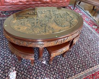 Very old Asian glass top table with six stools.