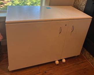 This is a Koala brand sewing machine table. It opens from both sides and the top and includes a space for your sewing machine as well as plenty of storage room