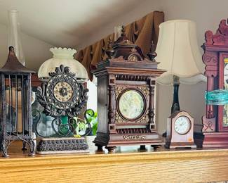Assorted clocks , more on the walls, including a large grandfather clock