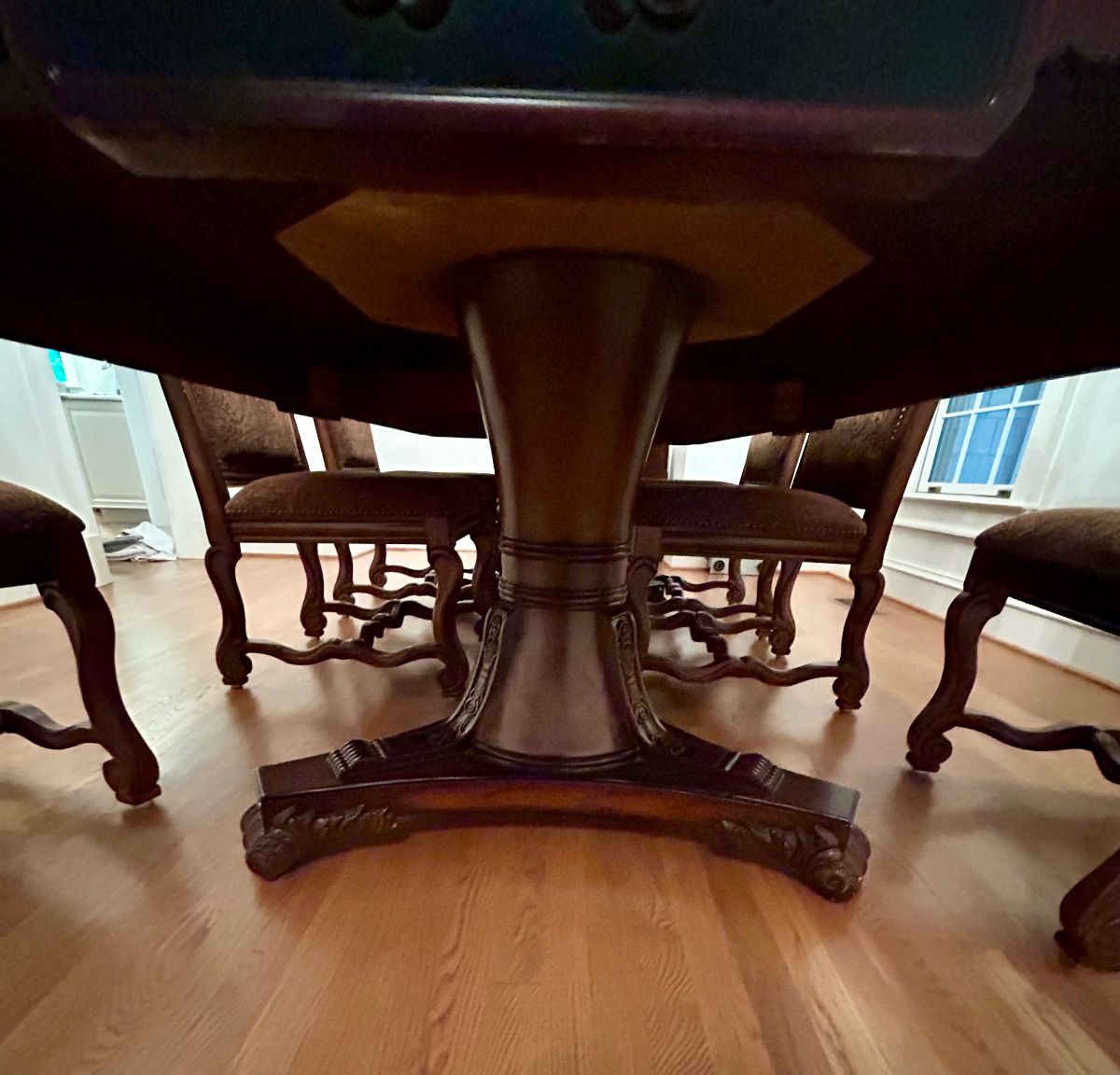 Intricately carved pedestal base with elegant scroll feet