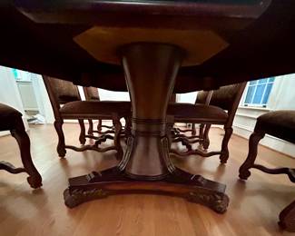 Intricately carved pedestal base with elegant scroll feet